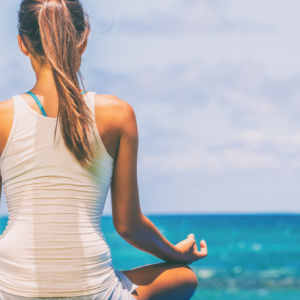 Wellness Retreats Services A woman practicing meditation at a Wellness Retreat